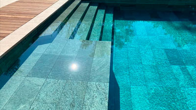 Sukabumi green stone tiles supplier for luxury swimming pools.